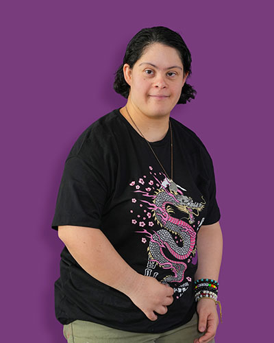 A portrait of our artist Sarah against a purple background - Mawaheb Art Studio for People of Determination