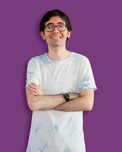 A portrait of our artist Sean against a purple background - Mawaheb Art Studio for People of Determination