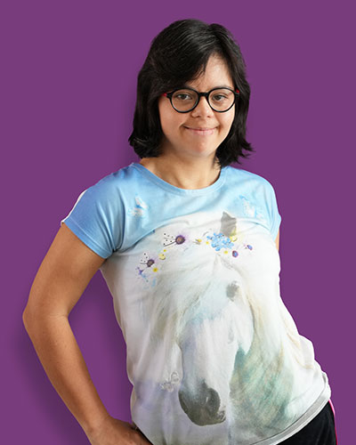 A portrait of our artist Verano against a purple background - Mawaheb Art Studio for People of Determination